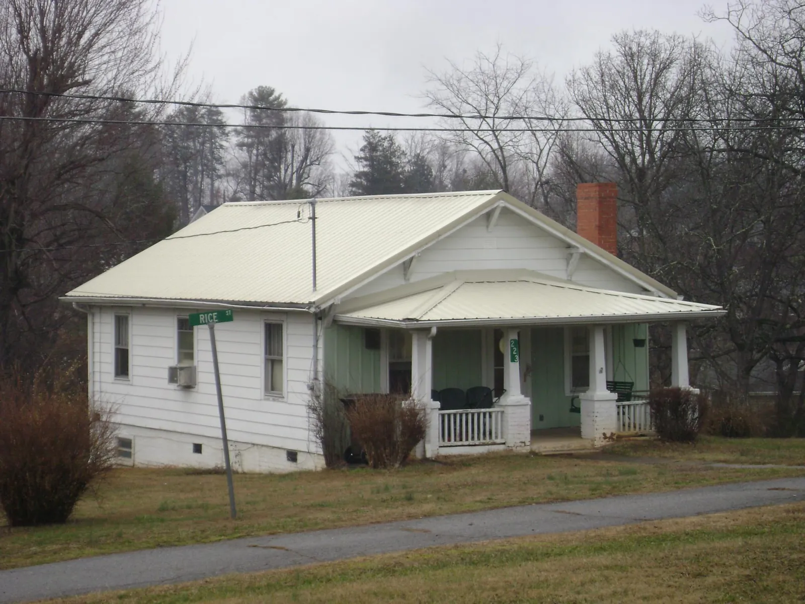 White metal roof on a craftsman bungalow at a street corner in Greensburg